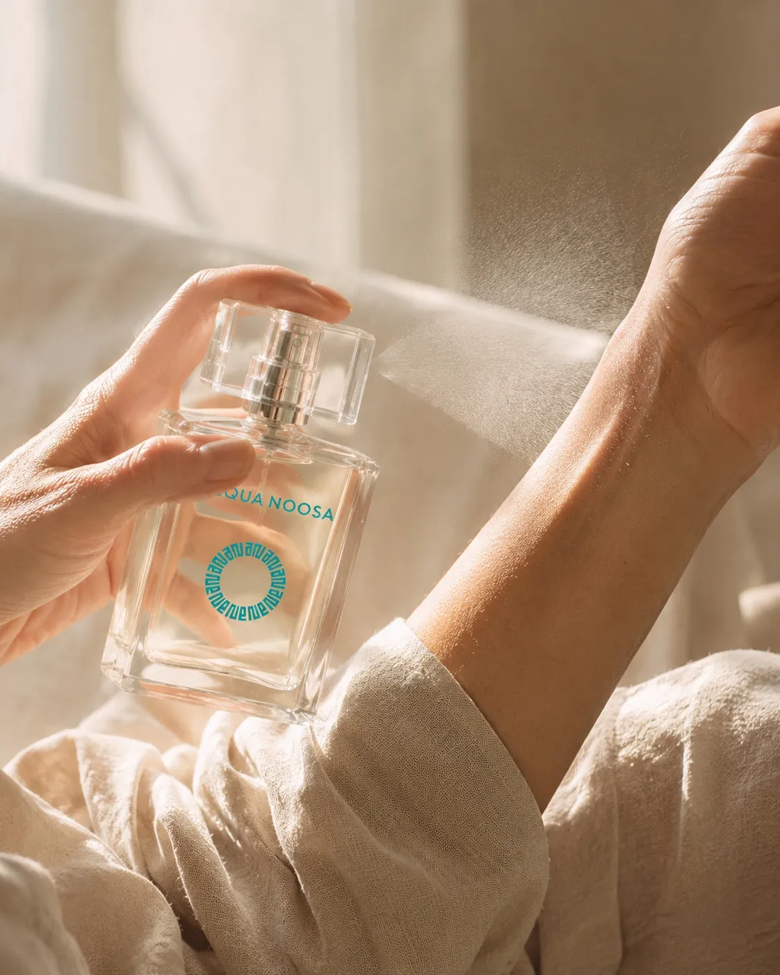 The 50ml bottle being sprayed onto an inner wrist in soft window light